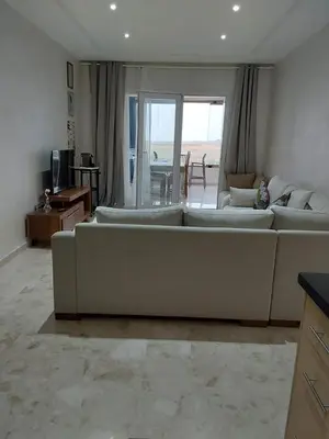 a large living room with a couch and a table at Evasion Prince 1 in Sidi el Haj Bou Derbala