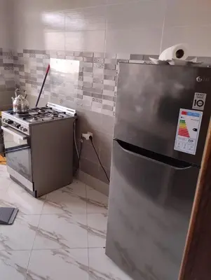 a kitchen with a stainless steel refrigerator and a stove at Settat, Morocco in Settat