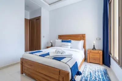 a bedroom with a bed with towels on it at Détente en Famille, Piscine, Plage à Proximité in Bouznika