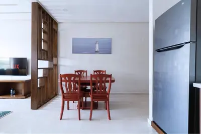 a dining room with a table and chairs and a lighthouse at Détente en Famille, Piscine, Plage à Proximité in Bouznika