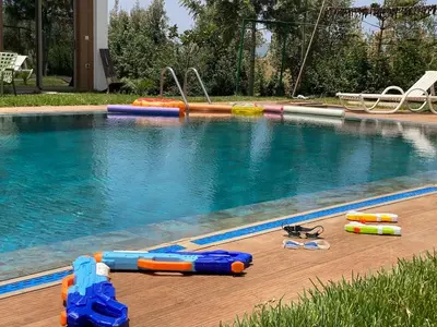 a swimming pool with toys and swimming equipment next to it at Farm - Private pool - Games - Nature in El Jadida