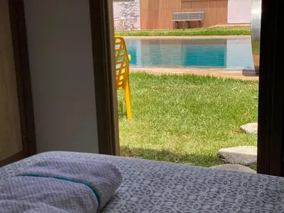 a bedroom with a window looking out at a pool at Farm - Private pool - Games - Nature in El Jadida