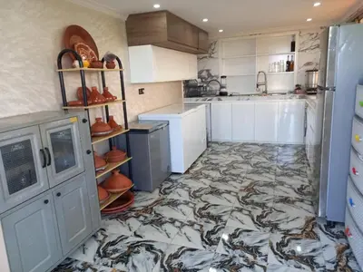 a kitchen with a fish patterned floor at Farm - Private pool - Games - Nature in El Jadida