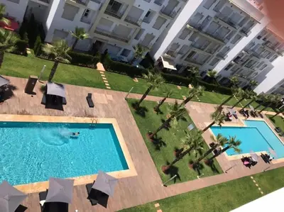 an overhead view of a swimming pool in front of a building at Appartement bouznika in Bouznika