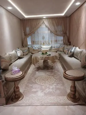 a living room with a couch and a table at Appartement bouznika in Bouznika