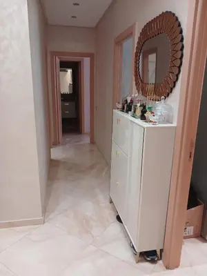 a bathroom with a mirror on top of a dresser at Appartement bouznika in Bouznika