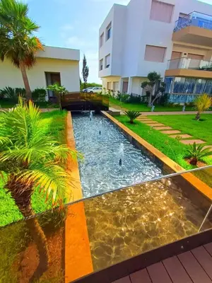 a swimming pool in front of a building at Les Sables de Sidi Rahal - Blue Beach in Sidi Rahal