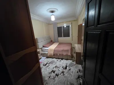 a small bedroom with a bed and a window at Appartement Souka Fitness in Bouznika