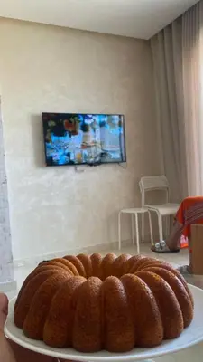 a brown cake on a plate on a table at Studio calme à Zenata in Aïn Harrouda