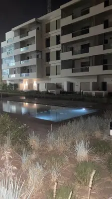 a building with a pool in front of it at night at Studio calme à Zenata in Aïn Harrouda