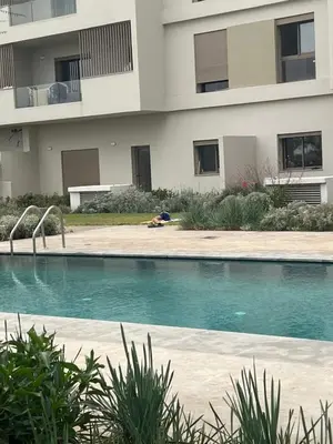 a swimming pool in front of a building at Studio calme à Zenata in Aïn Harrouda