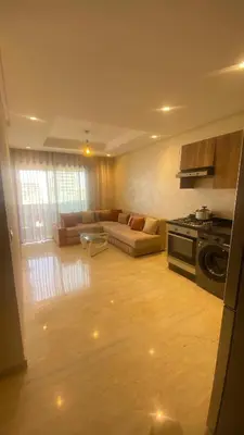 a living room with a couch and a stove at Studio calme à Zenata in Aïn Harrouda