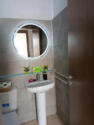 a bathroom with a sink and a mirror and a toilet at Cosy Bernoussi in Casablanca