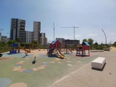 a park with a playground with a slide at Superbe duplex avec vue mer in Aïn Harrouda