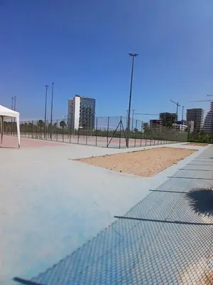a volley ball court with a volleyball net and a beach at Superbe duplex avec vue mer in Aïn Harrouda