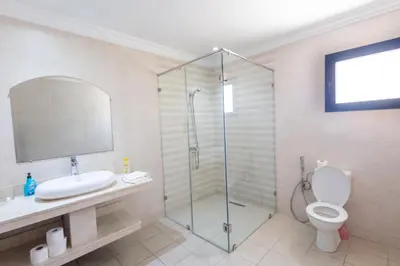 a bathroom with a shower and a toilet and a sink at Villa avec piscine et sauna 8 chambres proche commodité et Casa Finance City in Casablanca