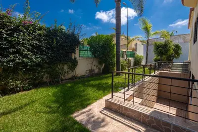 a stairway in a yard with grass and trees at Villa avec piscine et sauna 8 chambres proche commodité et Casa Finance City in Casablanca