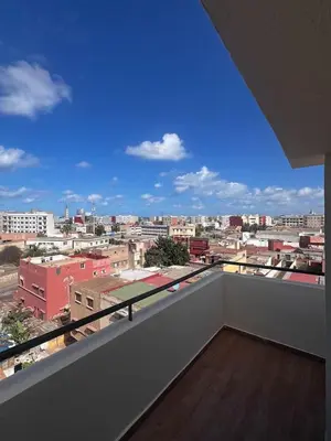 a balcony with a view of a city at Appartement de luxe avec parking gratuit à Casablanca, Vue & Confort in Aïn Sebaa
