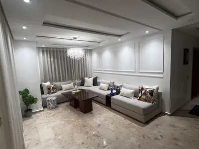 a living room with a couch and a table at Appartement de luxe avec parking gratuit à Casablanca, Vue & Confort in Aïn Sebaa