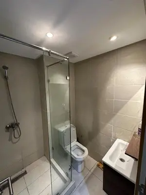 a bathroom with a shower and a toilet and a sink at Residence Bleu Dhalia in Sidi Rahal