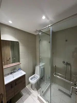 a bathroom with a shower and a toilet and a sink at Residence Bleu Dhalia in Sidi Rahal