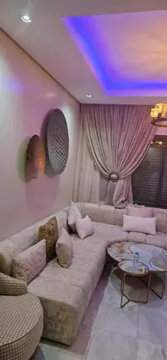 a living room with a couch and a table at Jnane californie in Casablanca
