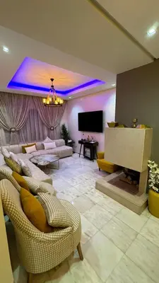 a large living room with couches and a tv at Jnane californie in Casablanca