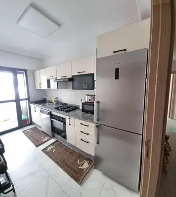 a kitchen with a stainless steel refrigerator at Luxueux Appartement Familial à Harhoura, Rabat Piscine & Plage à pied in Temara