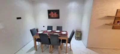 a dining room with a table and chairs at Luxueux Appartement Familial à Harhoura, Rabat Piscine & Plage à pied in Temara