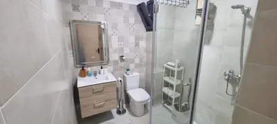 a bathroom with a toilet and a sink and a shower at Luxueux Appartement Familial à Harhoura, Rabat Piscine & Plage à pied in Temara