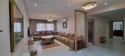 a living room with a couch and a table at Luxueux Appartement Familial à Harhoura, Rabat Piscine & Plage à pied in Temara