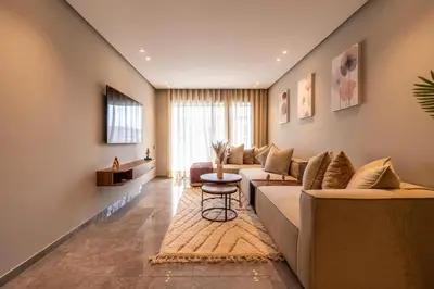 a living room with a couch and a table at Studio 1BR Near CFC - 5 Stars Experience in LʼOasis