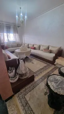 a living room with two couches and a table at Appartement Meublé avec Parking Gratuit, Calme & Pratique à Casablanca in Aïn Sebaa