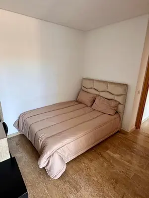 a bedroom with a large bed in a room at Sunny 2-Bedroom Apartment with Pool for a Great Stay in Mohammedia