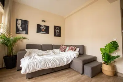 a bed and a couch in a room with pictures at Duplex au centre de Rabat in Rabat