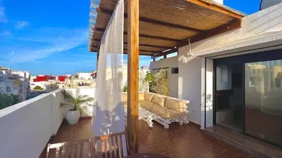 a balcony with a couch on a roof at Duplex au centre de Rabat in Rabat