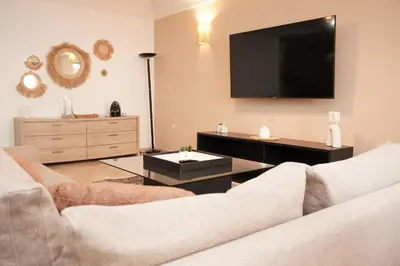 a living room with a couch and a flat screen tv at Cosy Loft - 2 Bedrooms & Parking - Agdal Center in Rabat