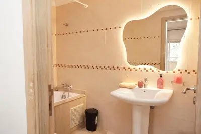 a bathroom with a sink and a mirror at Cosy Loft - 2 Bedrooms & Parking - Agdal Center in Rabat