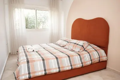 a bedroom with a bed with a plaid blanket at Cosy Loft - 2 Bedrooms & Parking - Agdal Center in Rabat