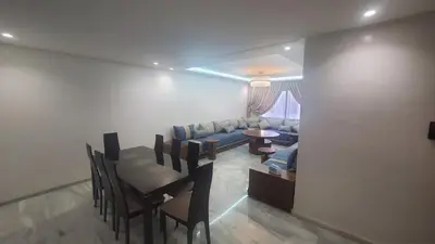 a living room with a couch and a table and chairs at Beautiful apartment 2 bedrooms living room aéroport mohamed 5 nouaceur Casablanca in Casablanca