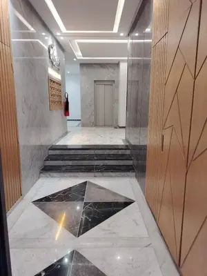 a hallway with a tile floor in a building at Beautiful apartment 2 bedrooms living room aéroport mohamed 5 nouaceur Casablanca in Casablanca
