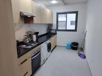 a kitchen with a sink and a stove top oven at Beautiful apartment 2 bedrooms living room aéroport mohamed 5 nouaceur Casablanca in Casablanca