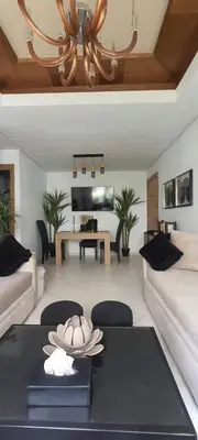 a living room with a table and a piano at Appartement avec Piscine à Tamaris, Confort, Vue Jardin et Plages à Proximité in Tamaris