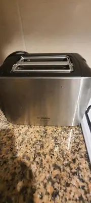 a toaster oven sitting on top of a counter at Appartement avec Piscine à Tamaris, Confort, Vue Jardin et Plages à Proximité in Tamaris