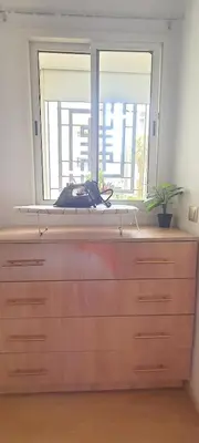 a wooden counter with a window in a room at Appartement avec Piscine à Tamaris, Confort, Vue Jardin et Plages à Proximité in Tamaris