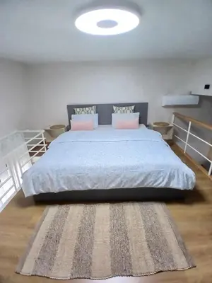 a bedroom with a large bed with a rug at Très beau studio Océan Park in Aïn Harrouda