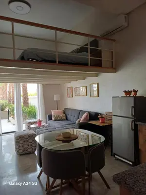 a living room with a couch and a bunk bed at Très beau studio Océan Park in Aïn Harrouda