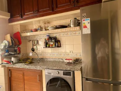 a kitchen with a refrigerator and a washing machine at Bedroom for girls only in Casablanca