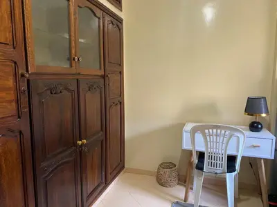 a desk with a chair next to a wooden cabinet at Bedroom for girls only in Casablanca