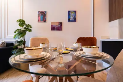 a dining room table with plates and glasses on it at Chic blue studio au cœur deCasablanca in Casablanca